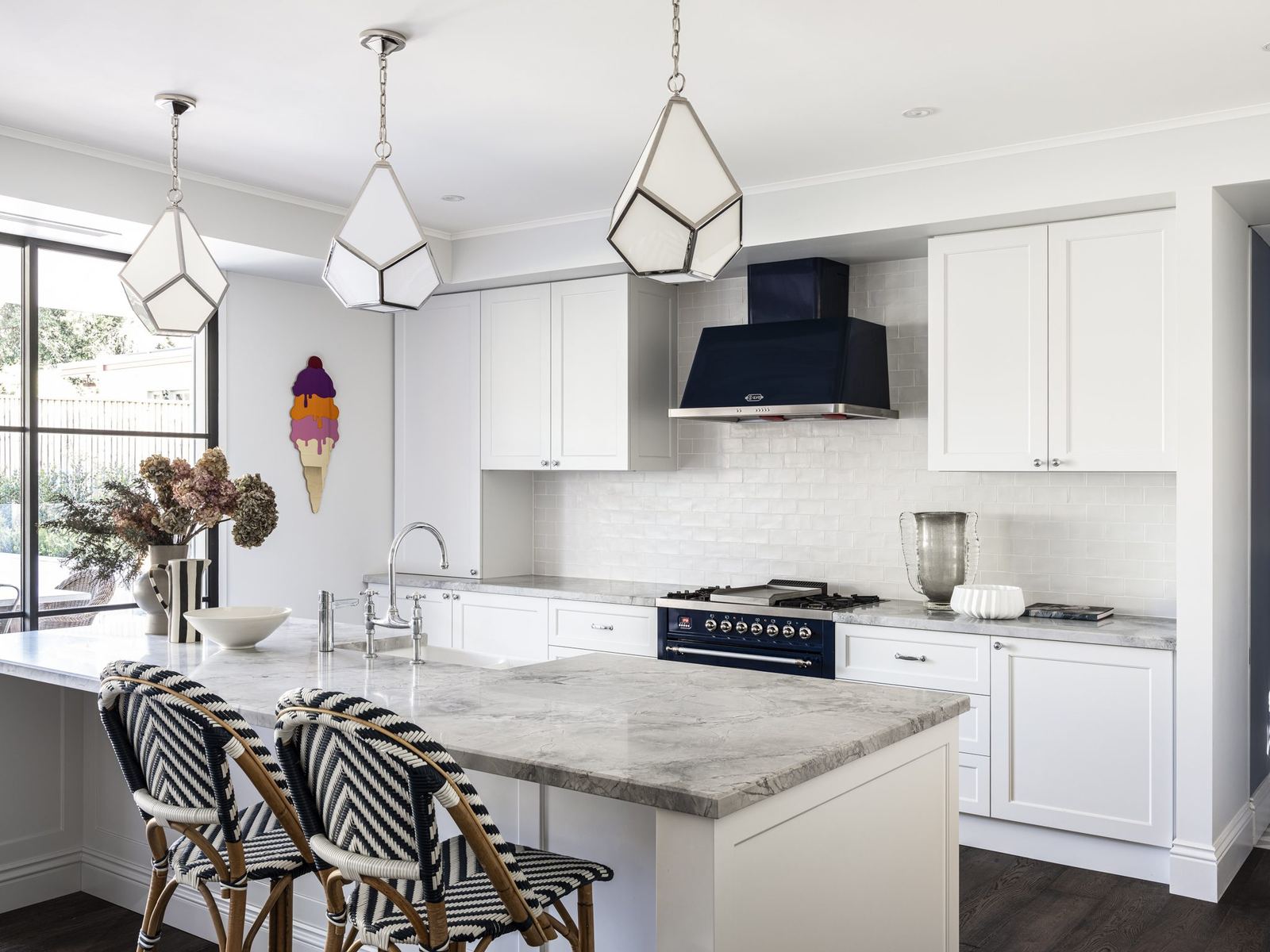 Willoughby — kitchen with marble island, rattan stools and black range, built by HP Constructions with Alexander & Co